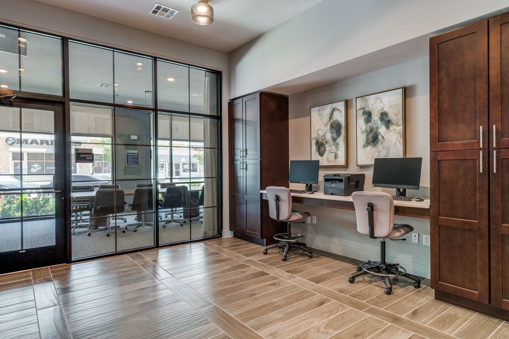 a conference room with desks and chairs and sliding glass doors