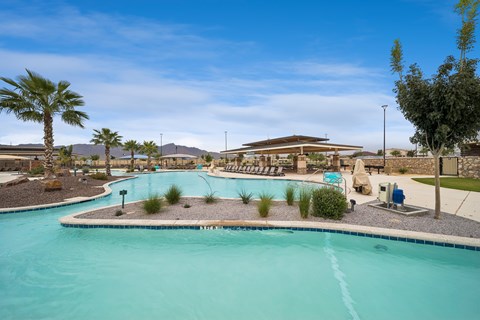 A large swimming pool with a small island in the middle.