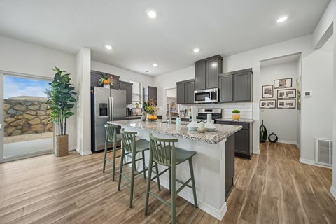 A modern kitchen with a dining table and chairs.