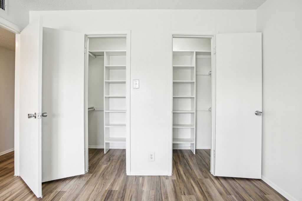 A white door with a silver handle is open.