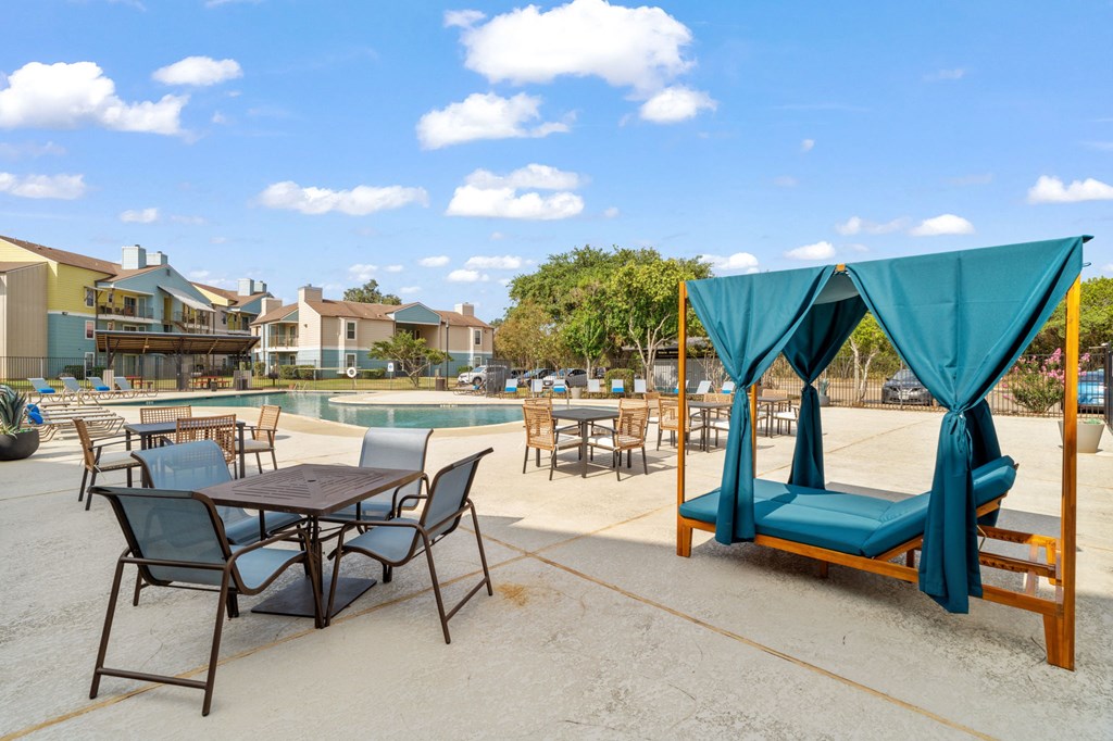 A patio with a table and chairs and a canopy.