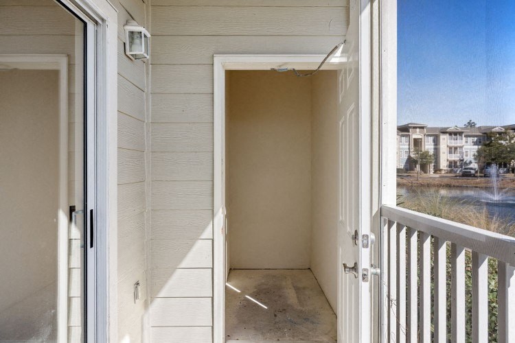 the view from the balcony of an apartment building with a door open