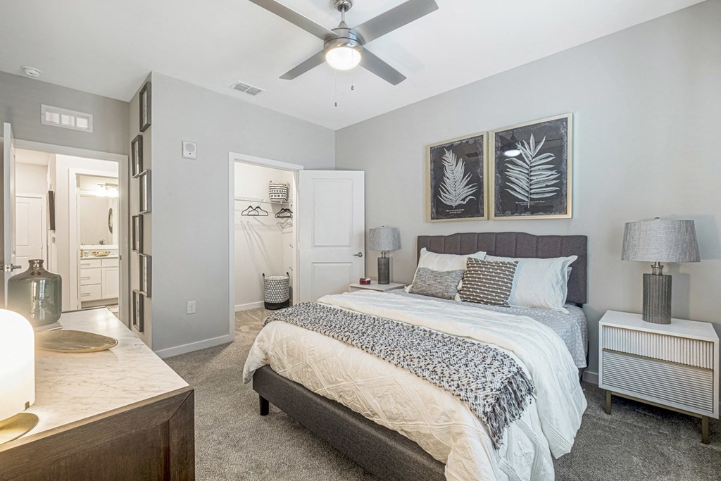 a bedroom with a large bed and a ceiling fan
