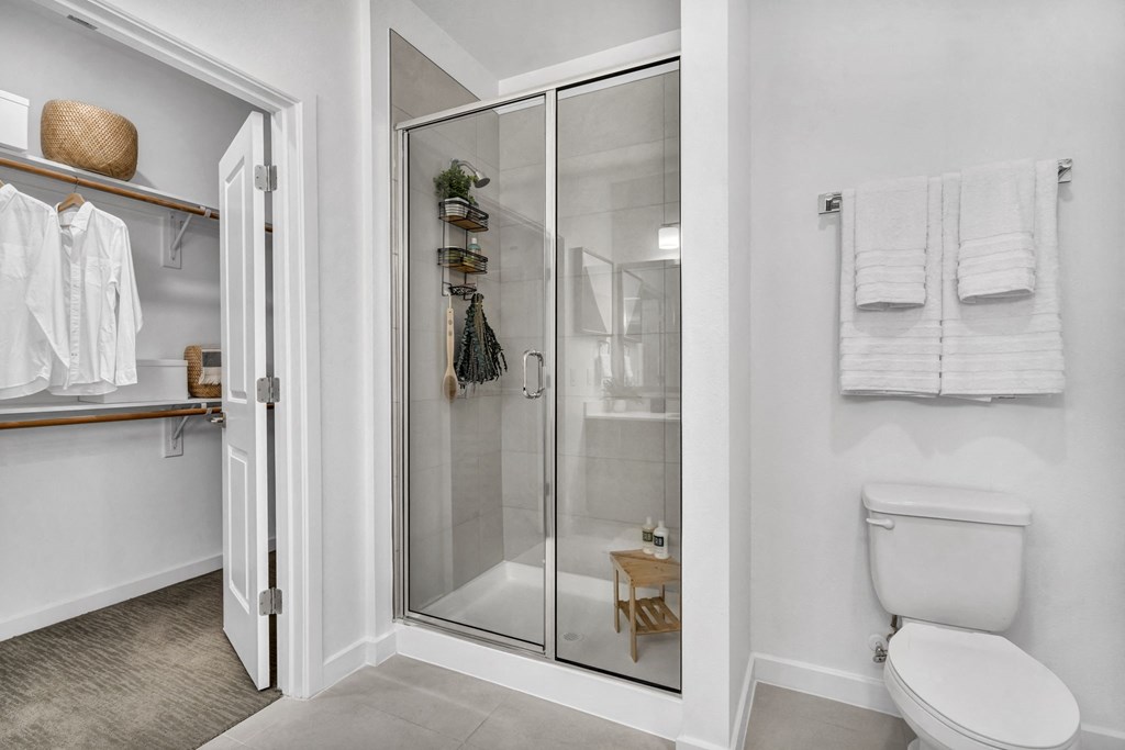 a white bathroom with a walk in shower
