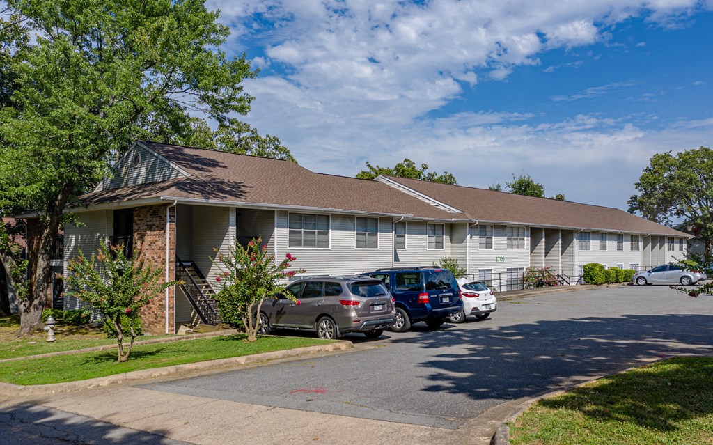 a white building with cars parked in front of it