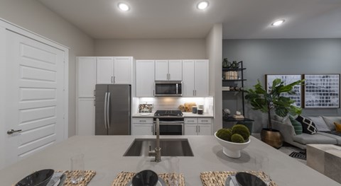 A modern kitchen with a dining table set for four.