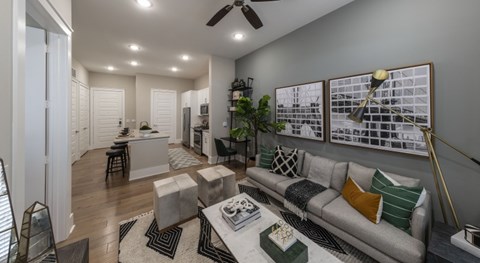 A modern living room with a grey sofa and a coffee table.