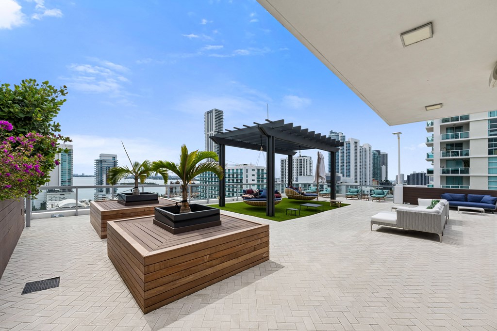 a large terrace with furniture and a pergola