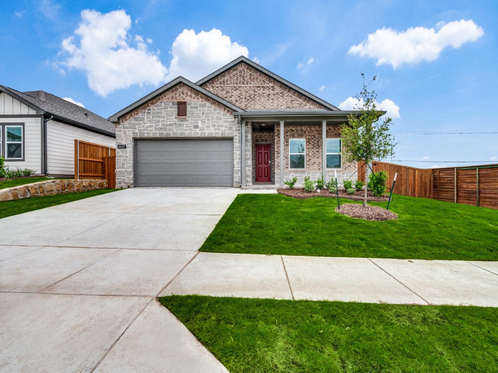 A house with a red door and a garage.