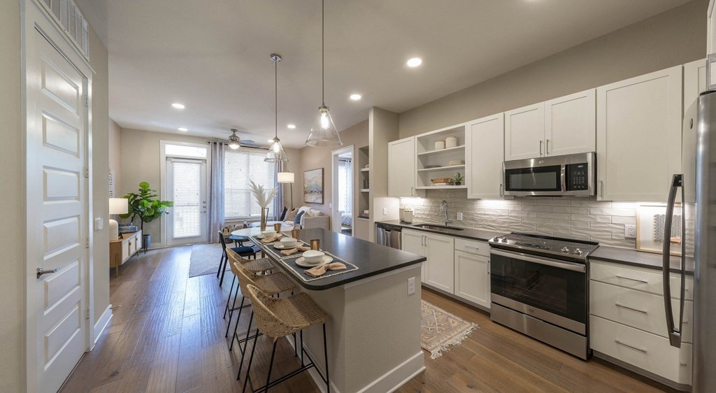 an open kitchen and dining room with a table and chairs
