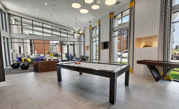 A spacious room with a pool table and comfortable seating.