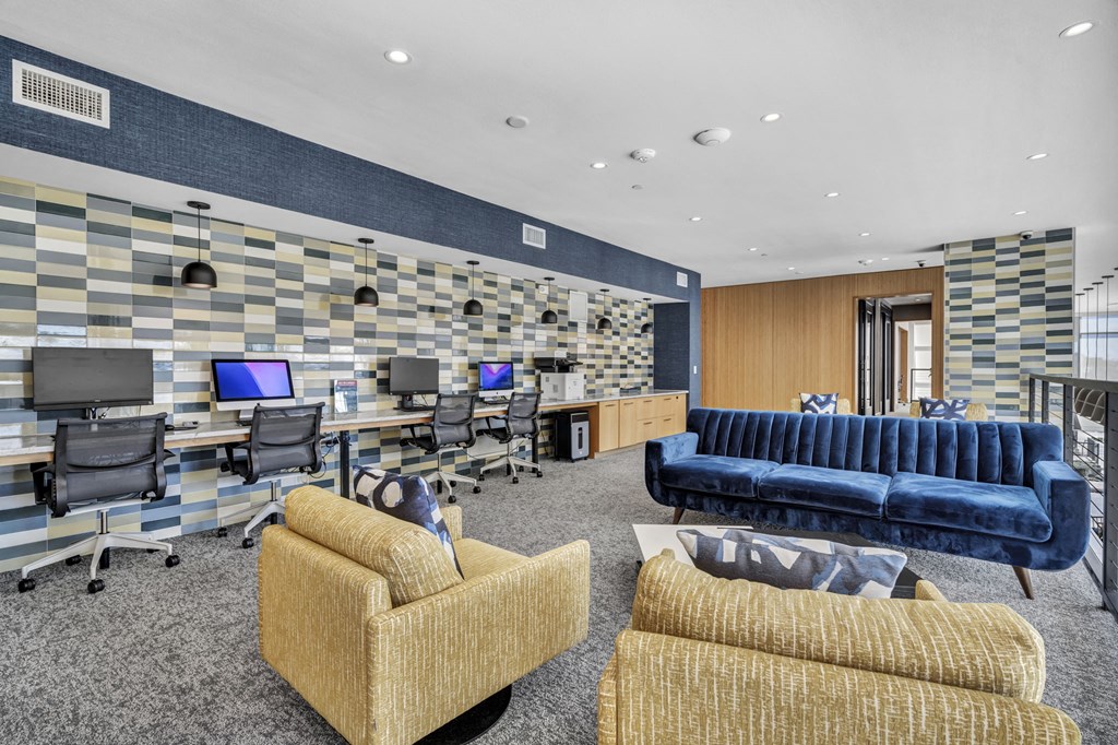 an airport lounge with chairs and tables and a purple ceiling