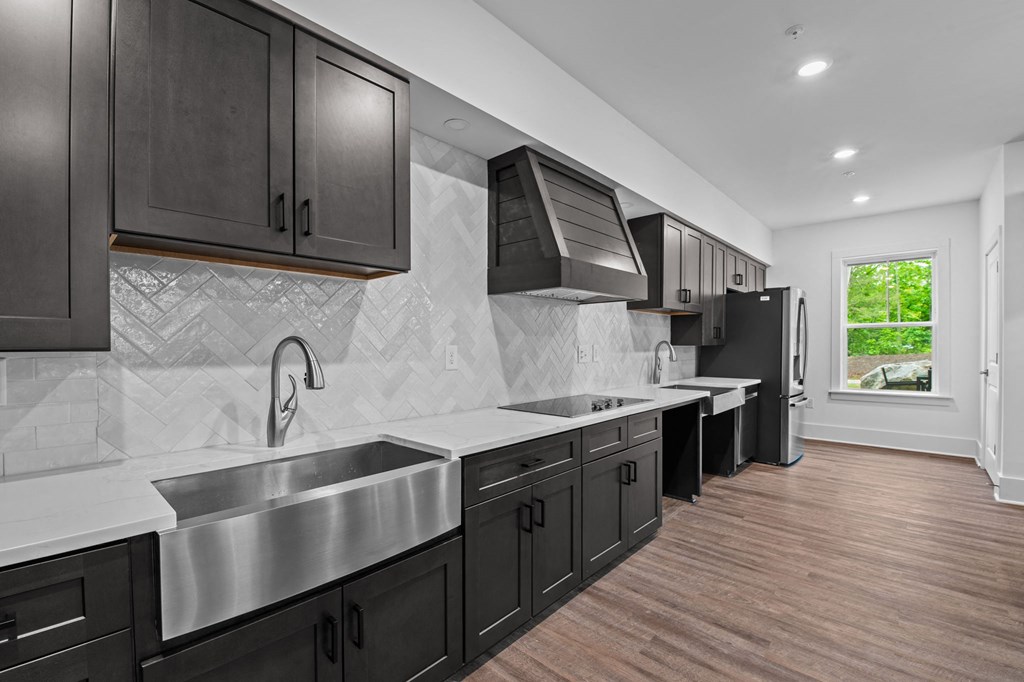 a kitchen with stainless steel appliances and black cabinets