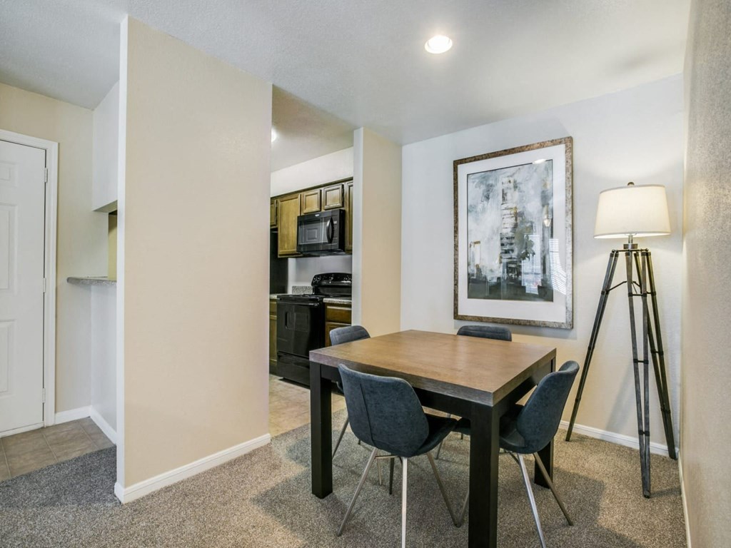 a dining room with a table and chairs and a tripod