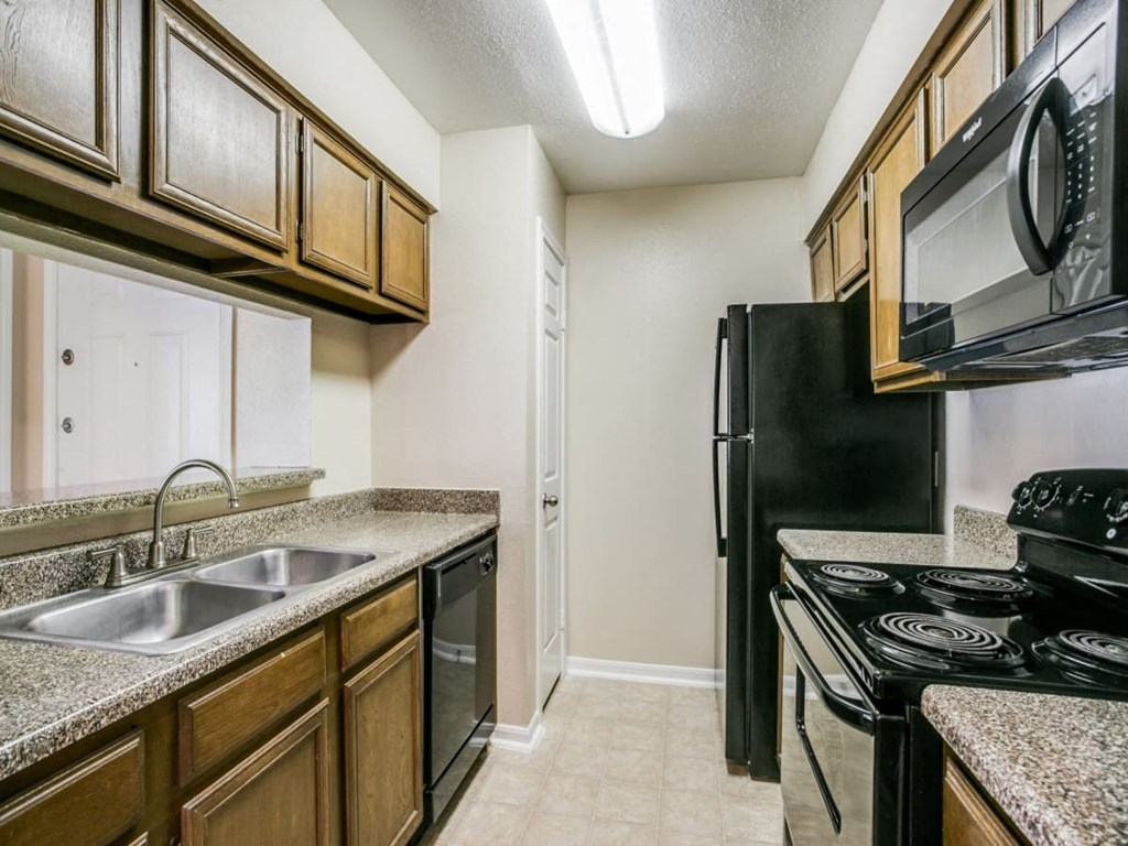a kitchen with a sink and a refrigerator