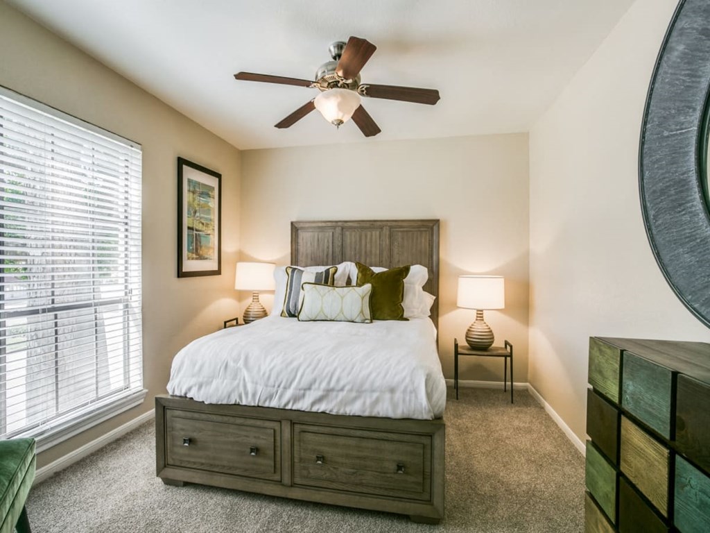 a bedroom with a bed and a ceiling fan