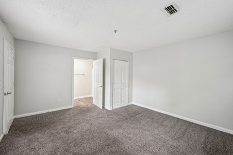 A room with carpeted floor and white walls.