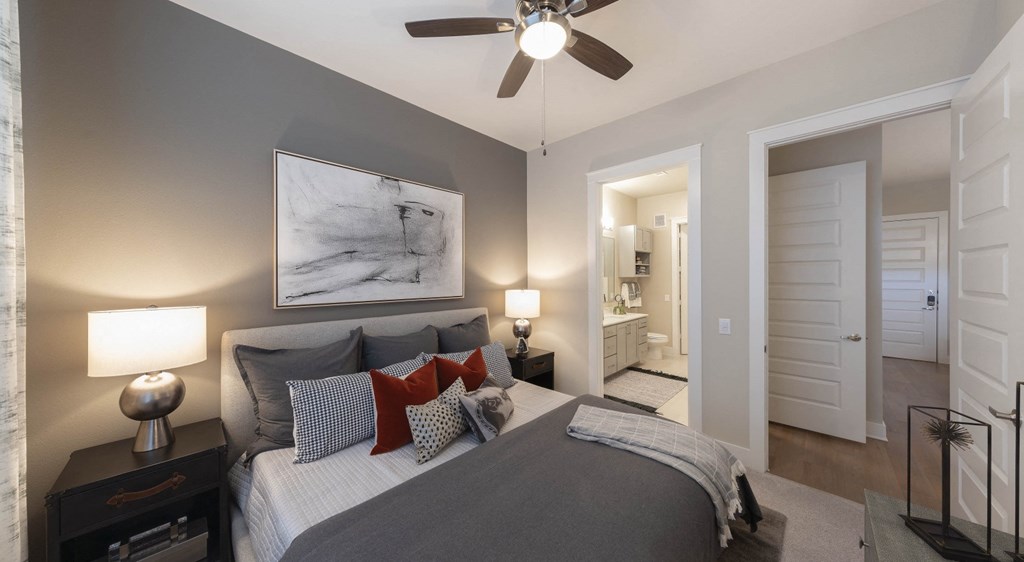 a bedroom with a large bed and a ceiling fan