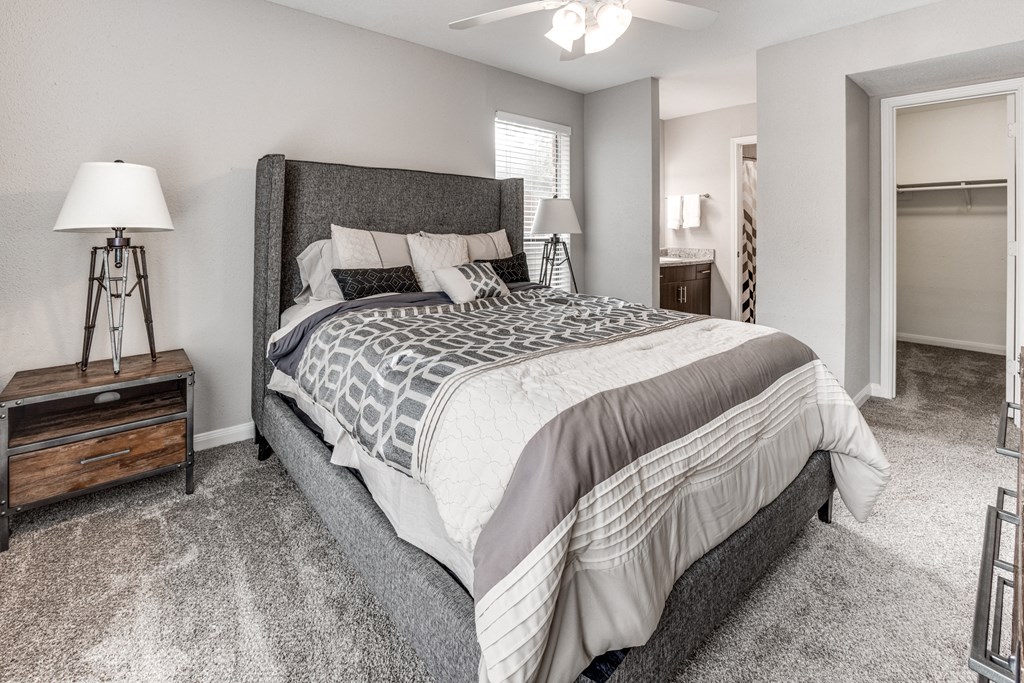 the master bedroom in a new home with gray carpet and a large bed