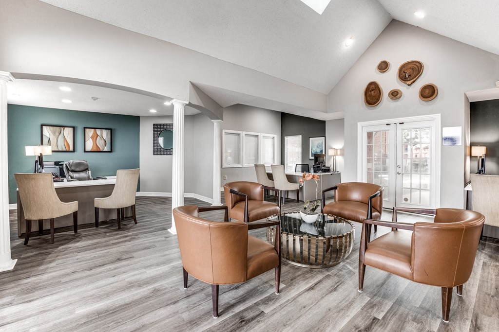 a living room with leather chairs and a dining room table