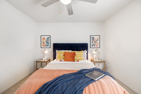 a bedroom with a large bed and a ceiling fan