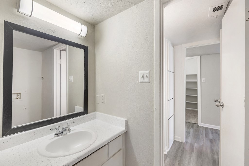a bathroom with two sinks and a mirror and a closet