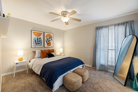 a bedroom with a large bed and a ceiling fan