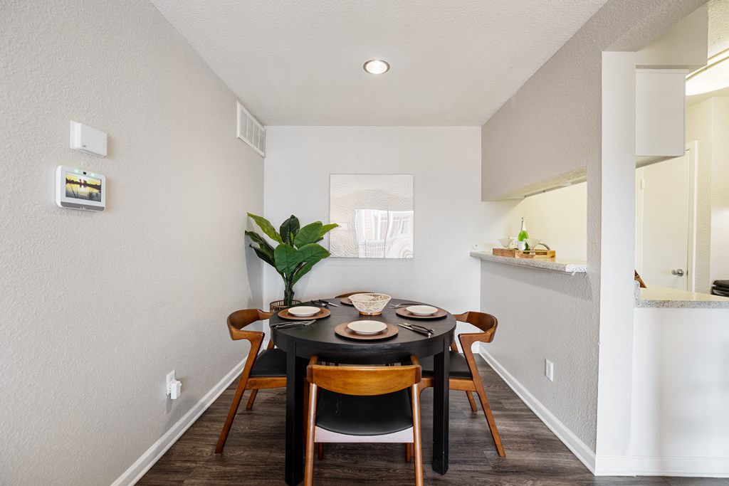 a dining room with a table and chairs