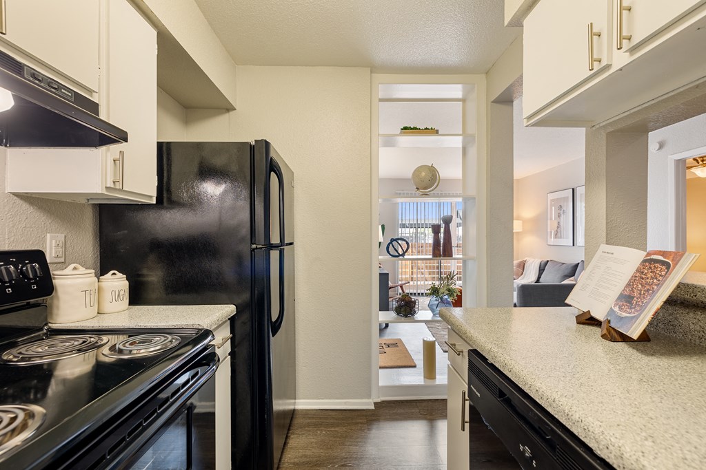 kitchen with black appliances and granite counter tops and a view of the living room