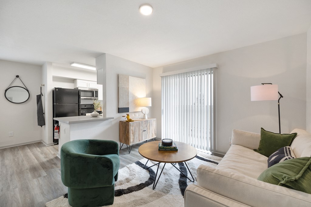 a living room with a couch and a chair and a table