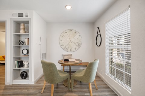 a dining room with a large clock on the wall