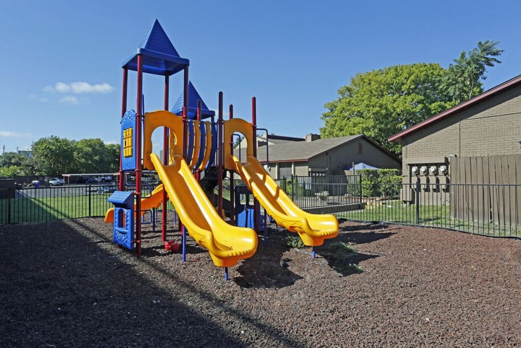 a playground with two slides at a park