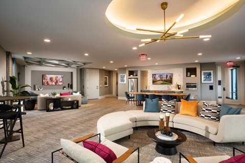 A modern living room with a white couch, a coffee table, and a ceiling fan.