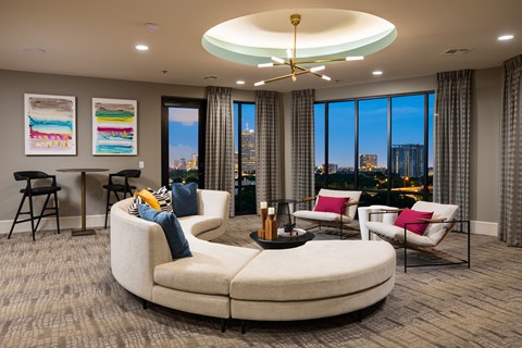 A modern living room with a large window overlooking the city.