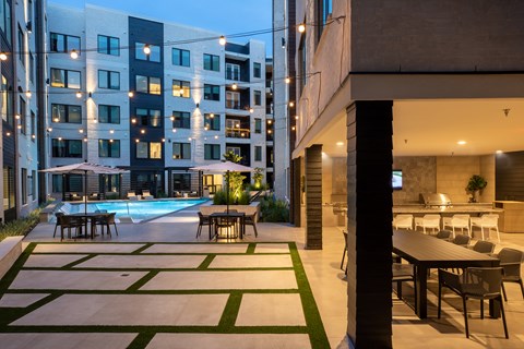 A modern building with a pool and a dining area.