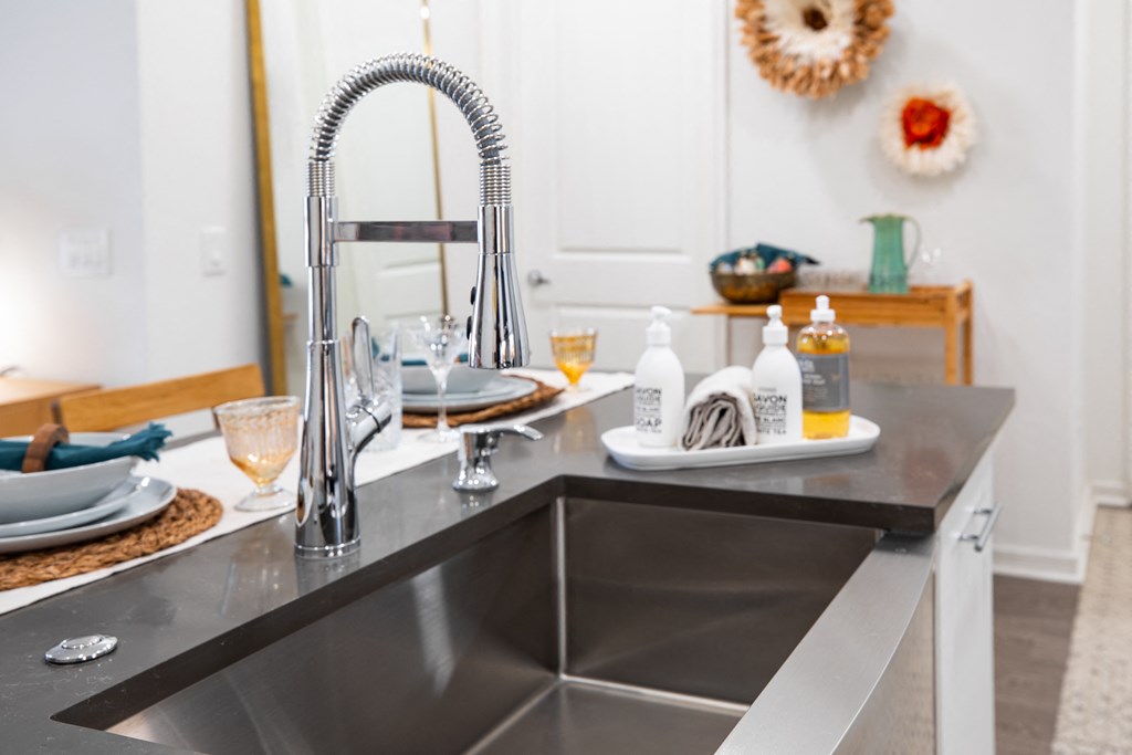 a kitchen with a sink and a counter with dishes on it