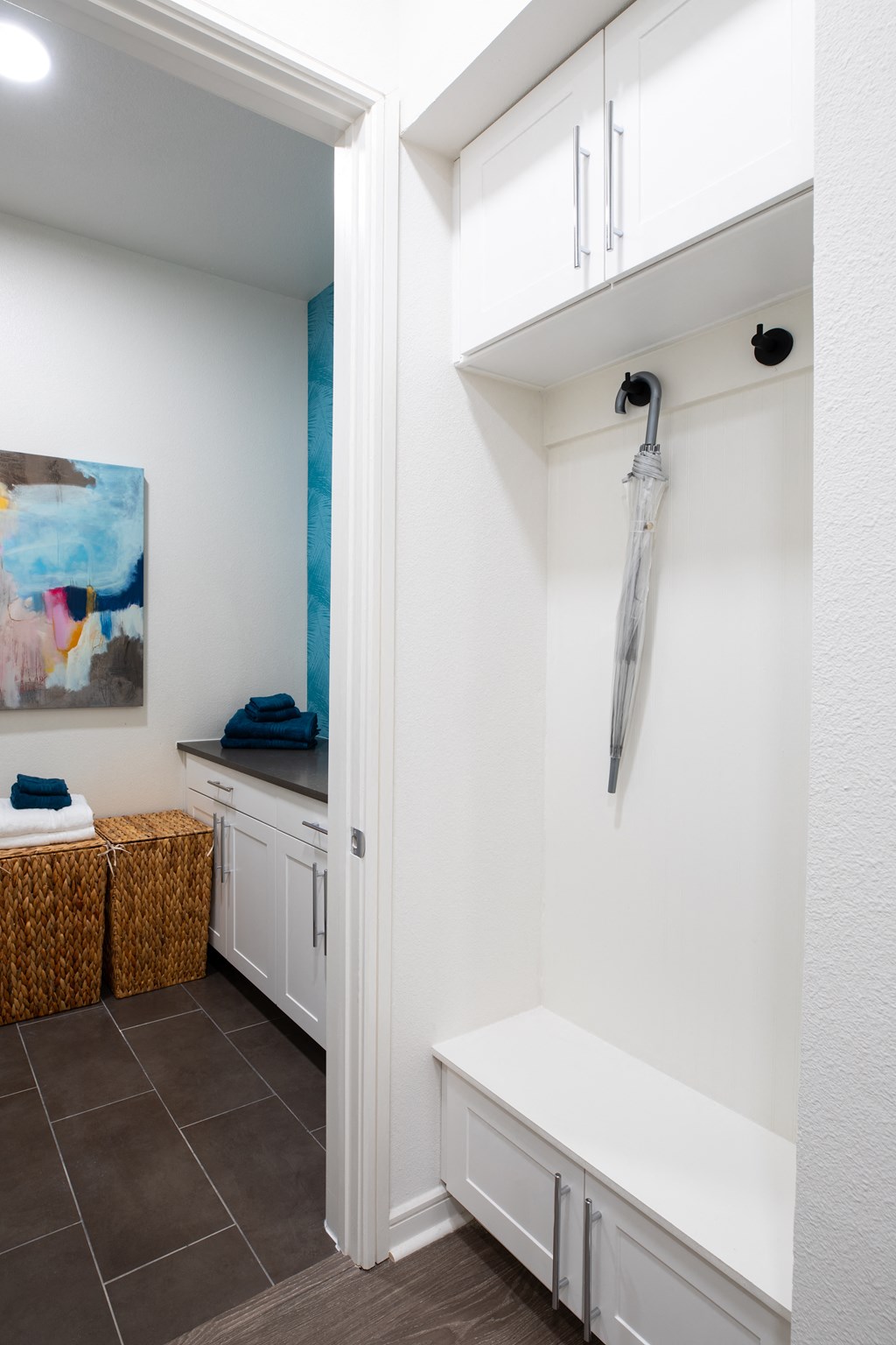 a bathroom with a shower and a sink and a white cabinet