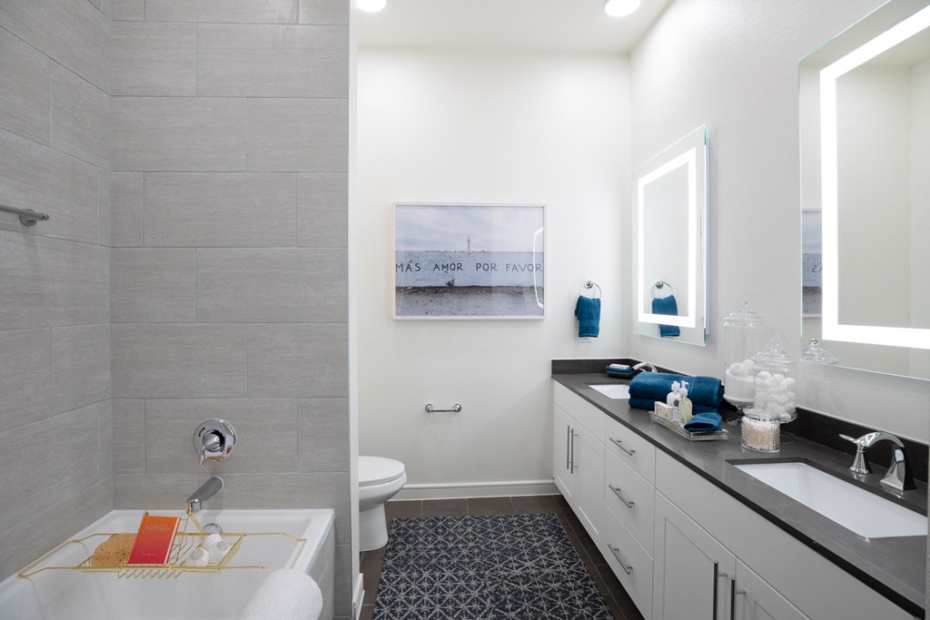 a bathroom with a sink and a toilet and a shower