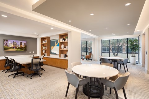 A conference room with a long table surrounded by chairs.