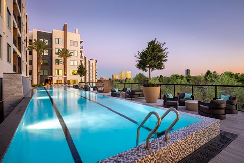 A swimming pool on a rooftop with a view of the city.