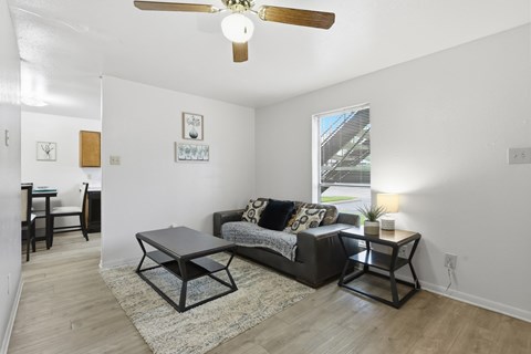 A living room with a black couch and a coffee table.