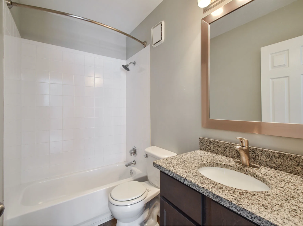 a bathroom with a toilet sink and bathtub