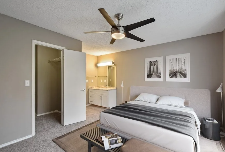 a bedroom with a bed and a ceiling fan