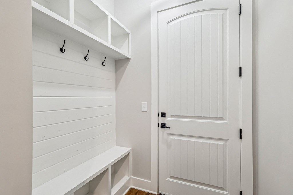 A white door is closed with a black handle.