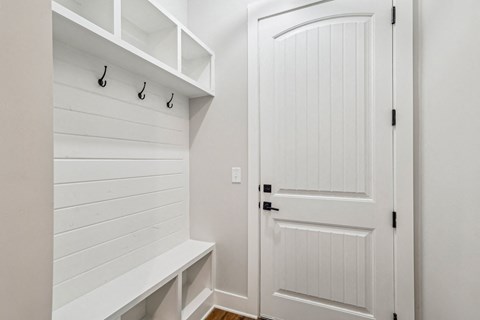 A white door is closed with a black handle.