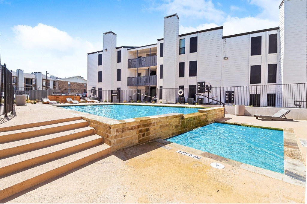 a swimming pool with a building in the background