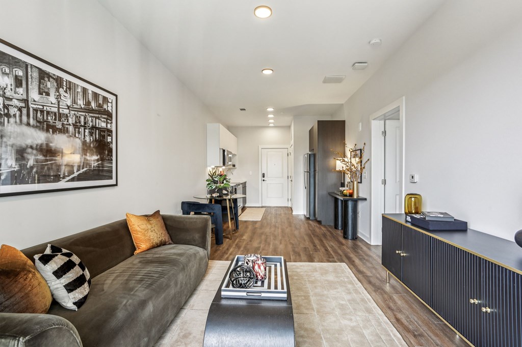 A living room with a brown couch and a coffee table.
