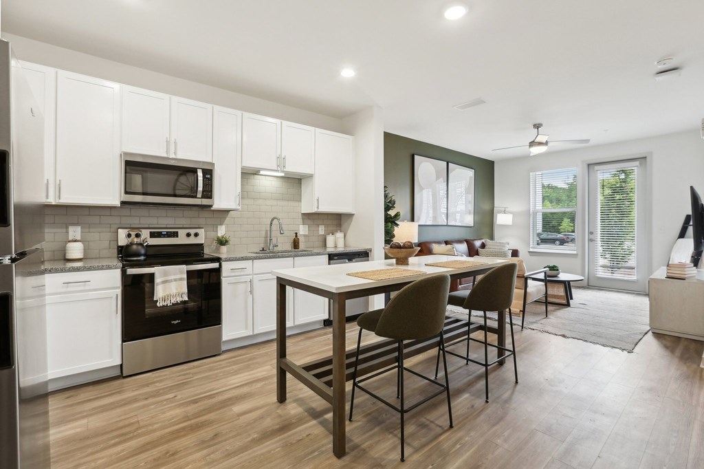A modern kitchen with a dining table and chairs.