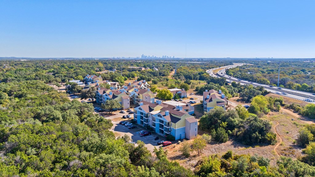 A bird's eye view of a residential area with houses surrounded by greenery.