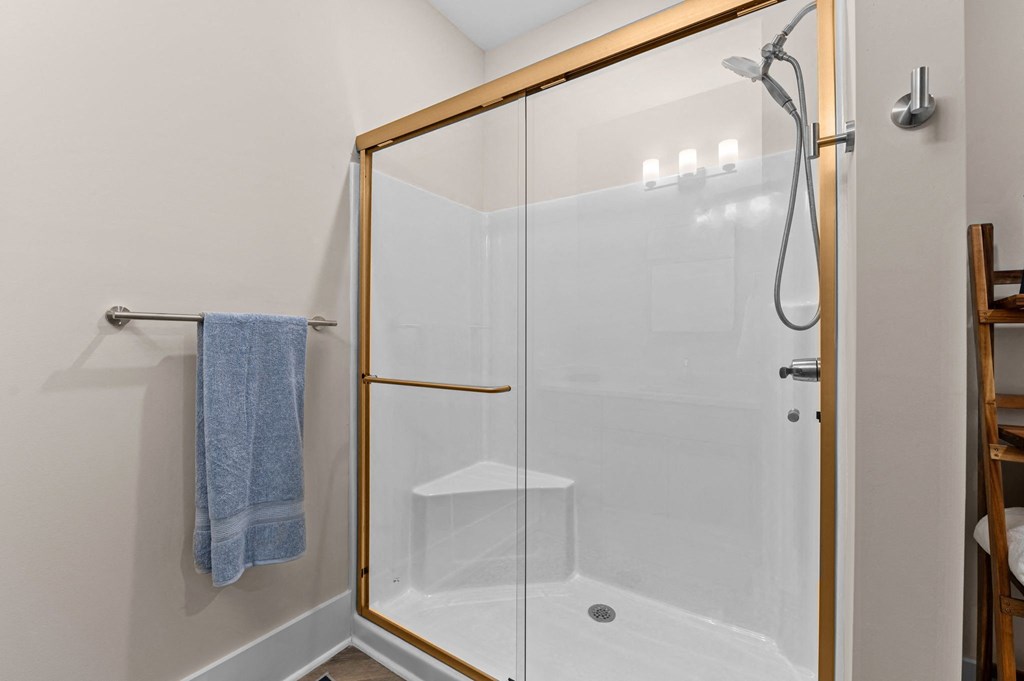 a shower with a glass door in a bathroom